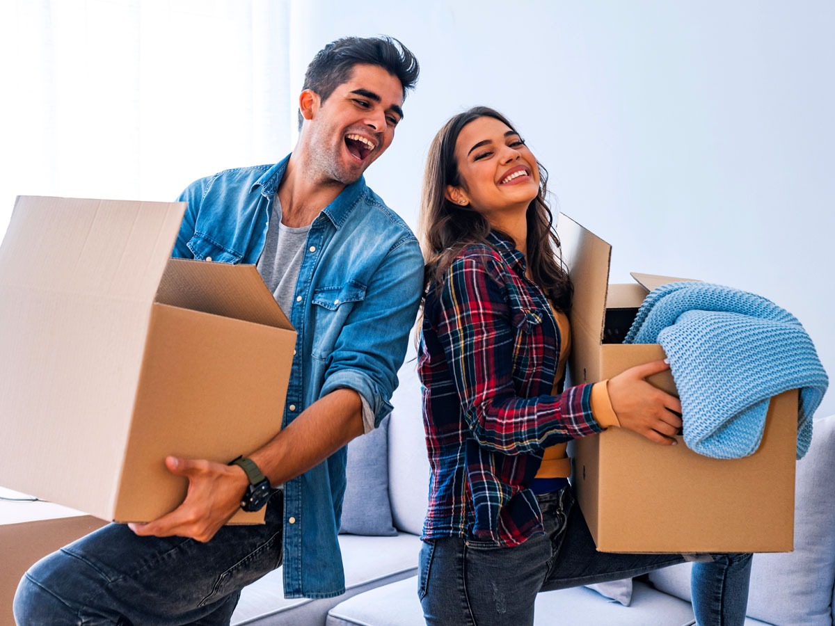 Young couple enjoy and celebrating moving to new home